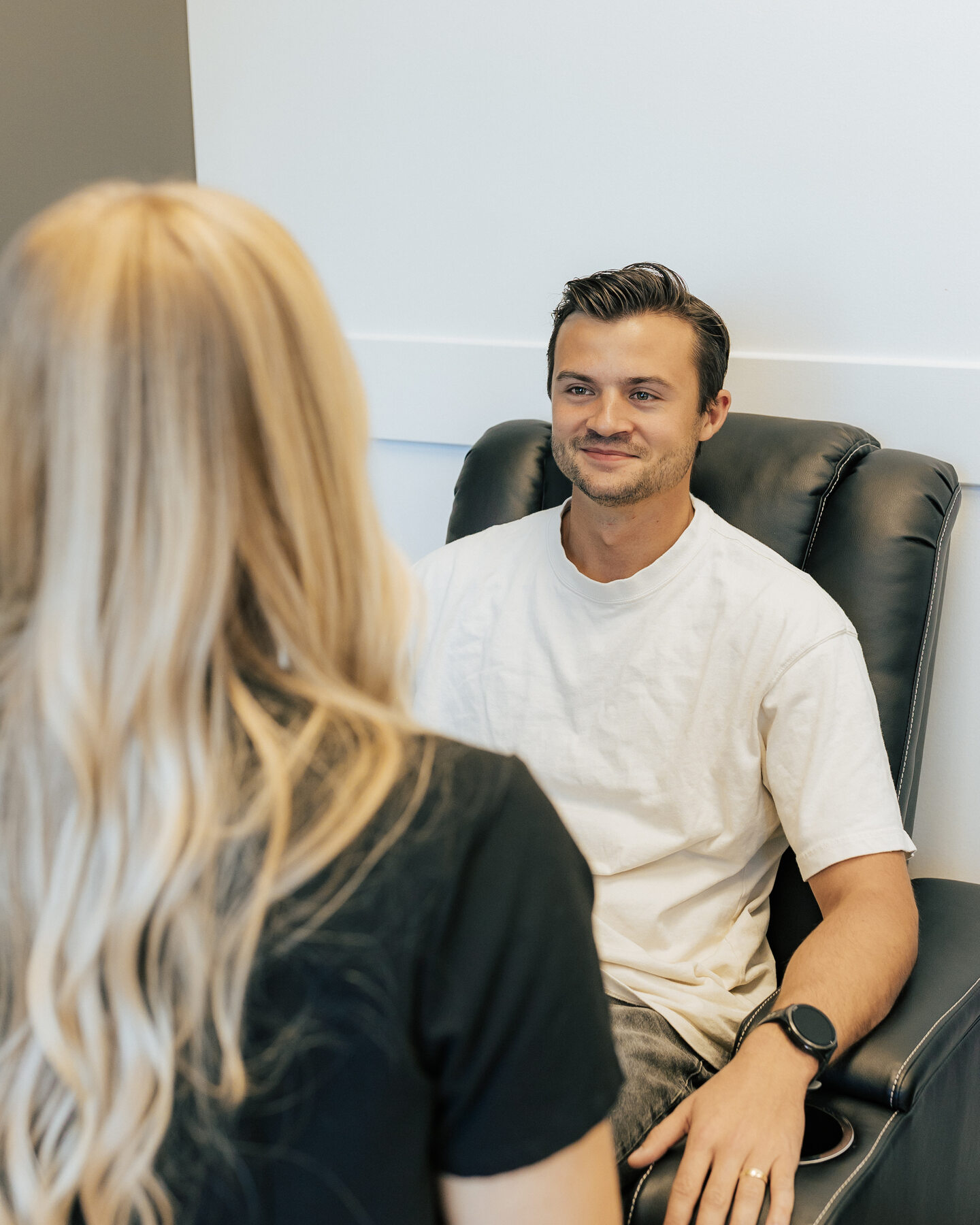 Two people talk during a one-to-one clinic consultation.