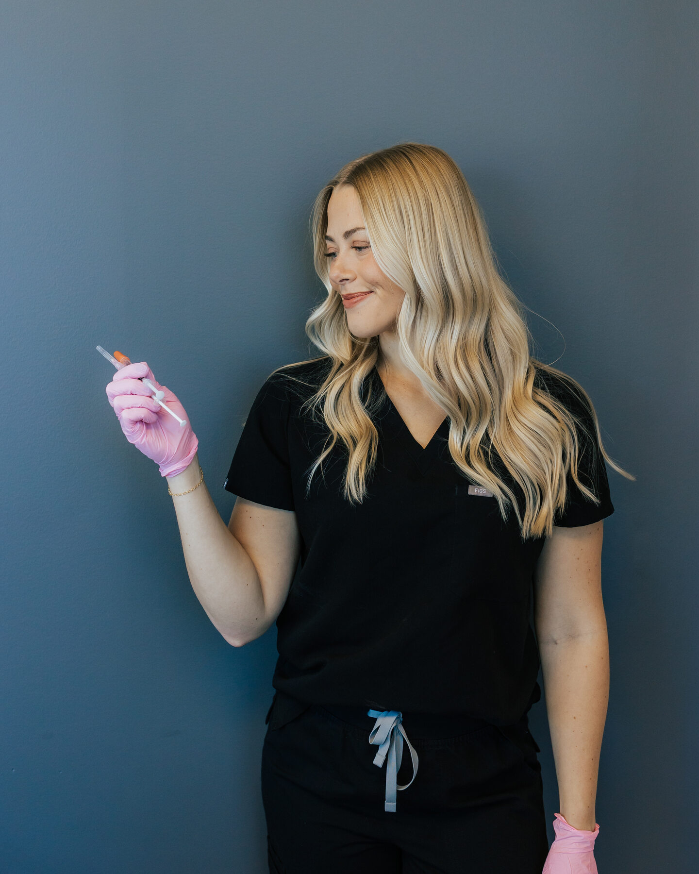 A clinician holds a small vial in a clinic room.